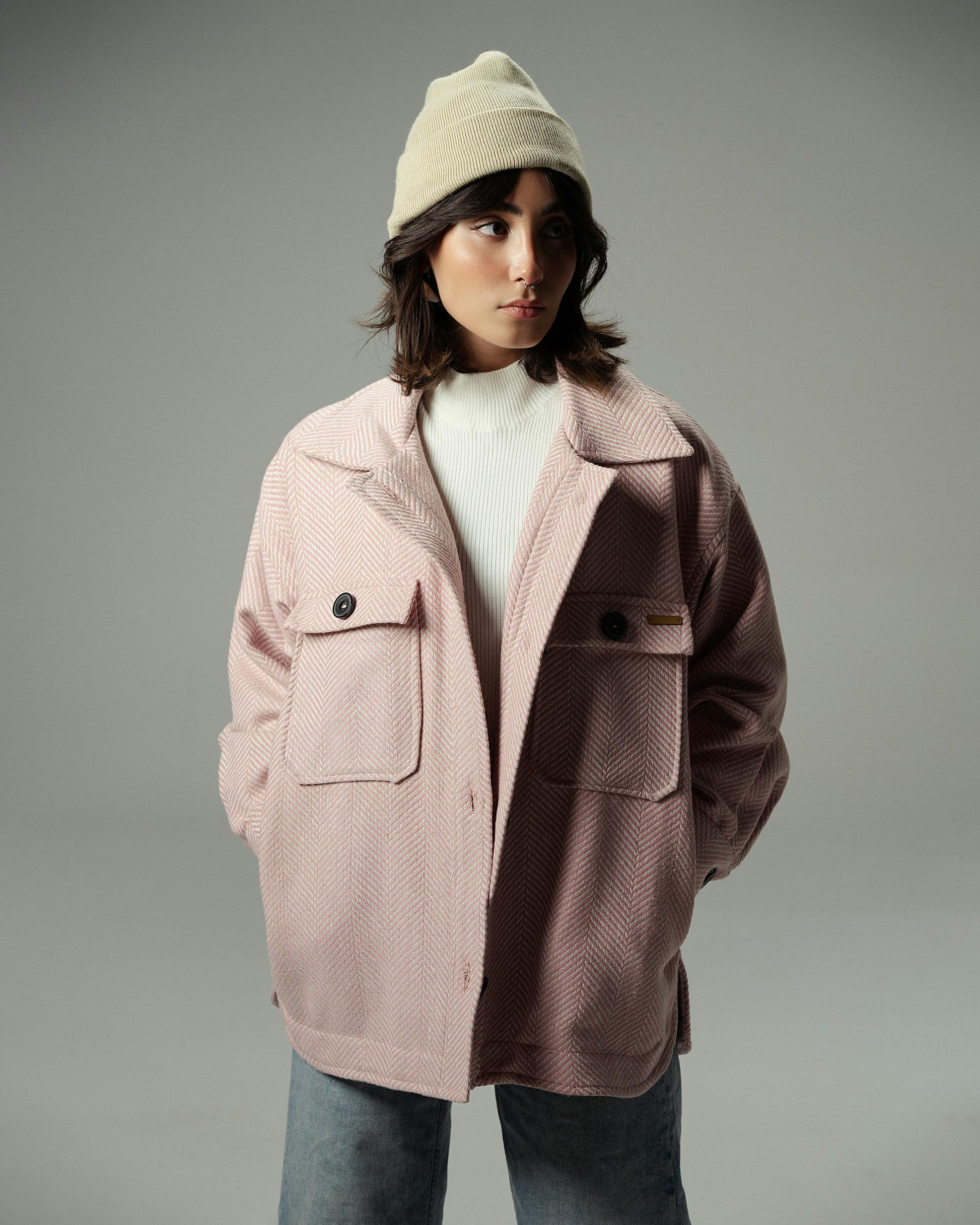 Person wearing a two-tone jacket with a gray background