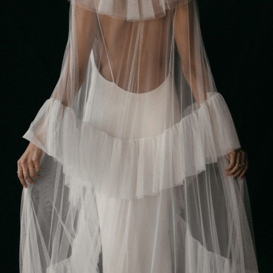 White dress with sheer overlay on a black background