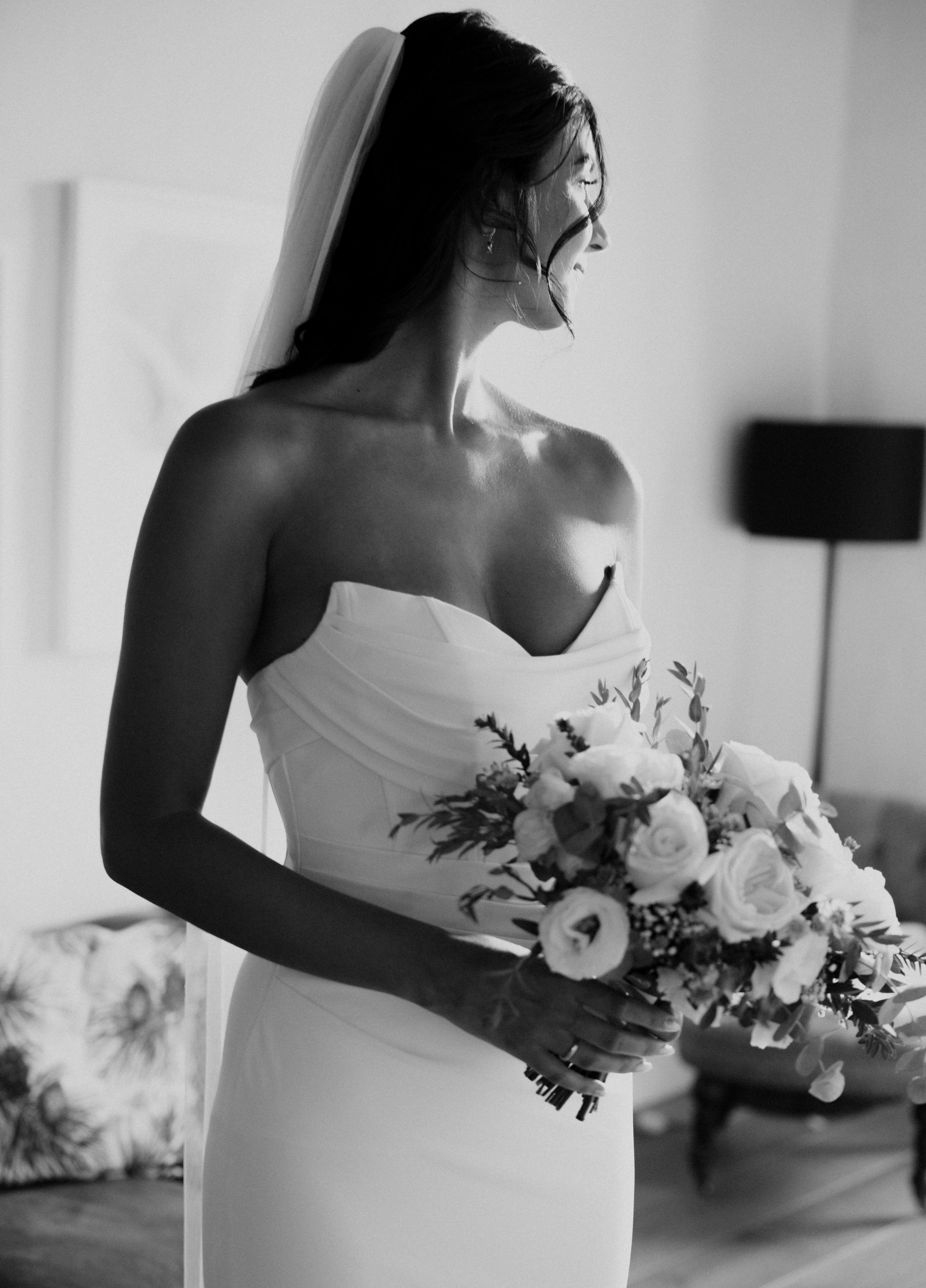 Black and white photo of a bride holding a bouquet indoors. Victoria Ellison is a Fashion Stylist specialising in Bridal Styling, Pregnancy Styling, Motherhood Styling, Personal Styling.